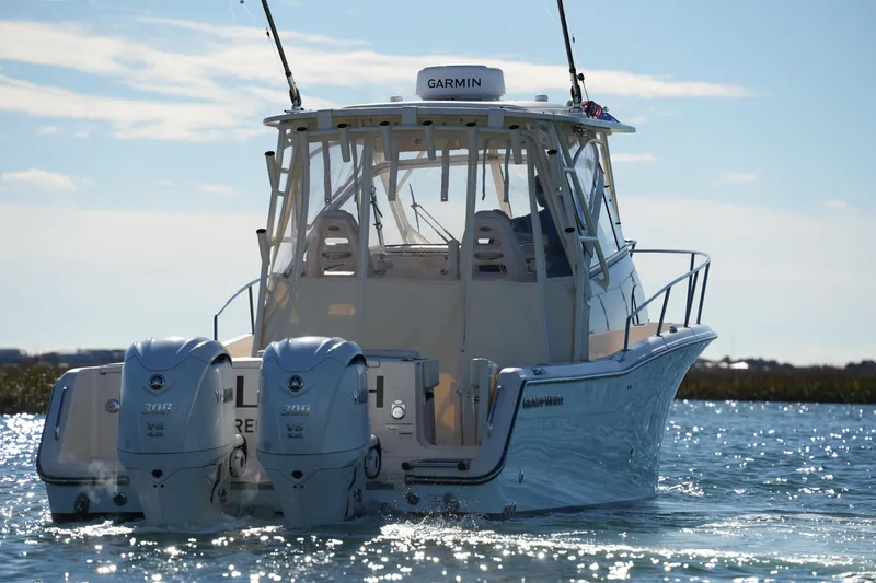 Slide: The Image of 2023 Grady-White Marlin 300 boat with twin Yamaha engines on water. - 8