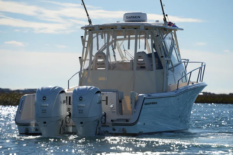 Slide: The Image of 2023 Grady-White Marlin 300 boat with twin Yamaha engines on water. - 9