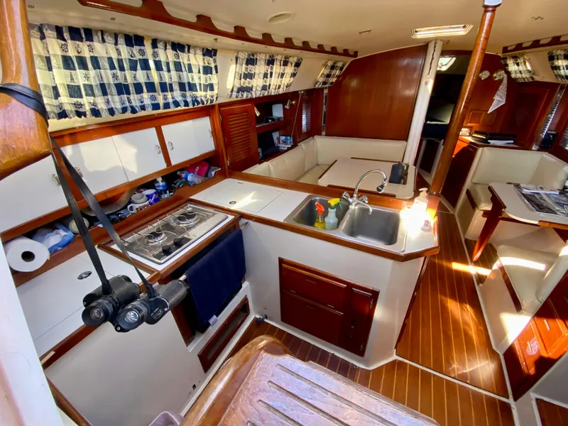 Slide: The Image of Interior of a 1989 Catalina 36 yacht with kitchen and seating area. - 10