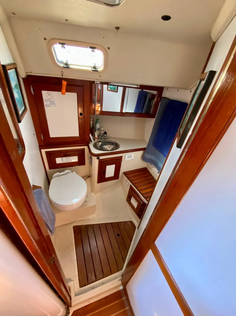 Slide: The Image of Interior of a 1989 Catalina 36 yacht with bathroom and wood trim. - 18
