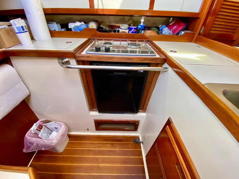 Slide: The Image of Galley area of a 1989 Catalina 36 yacht with stove and wood trim. - 25