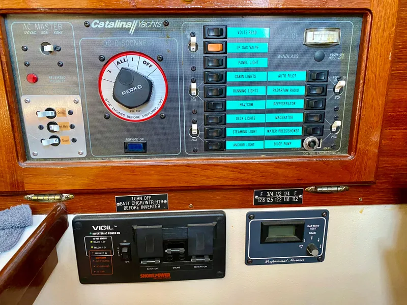 Slide: The Image of Control panel of a 1989 Catalina 36 yacht with switches and gauges. - 27