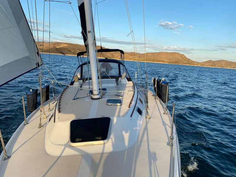 Slide: The Image of 1989 Catalina 36 sailboat on open sea at sunset. - 39