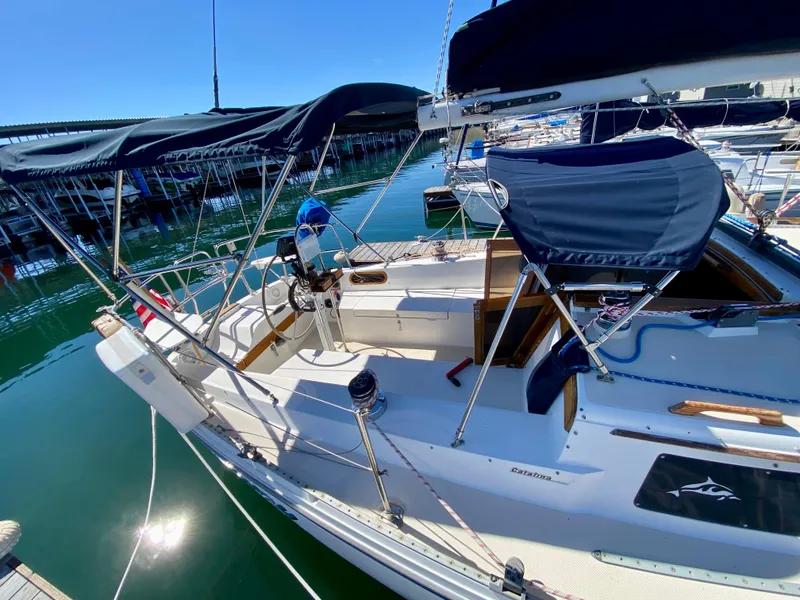 Slide: The Image of 1989 Catalina 36 sailboat docked on a sunny day. - 7