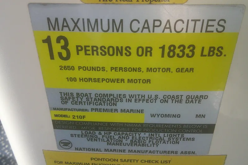Slide: The Image of 1998 Premier 210 Sunsation boat capacity label: 13 persons, 1833 lbs, 100 horsepower motor. - 10