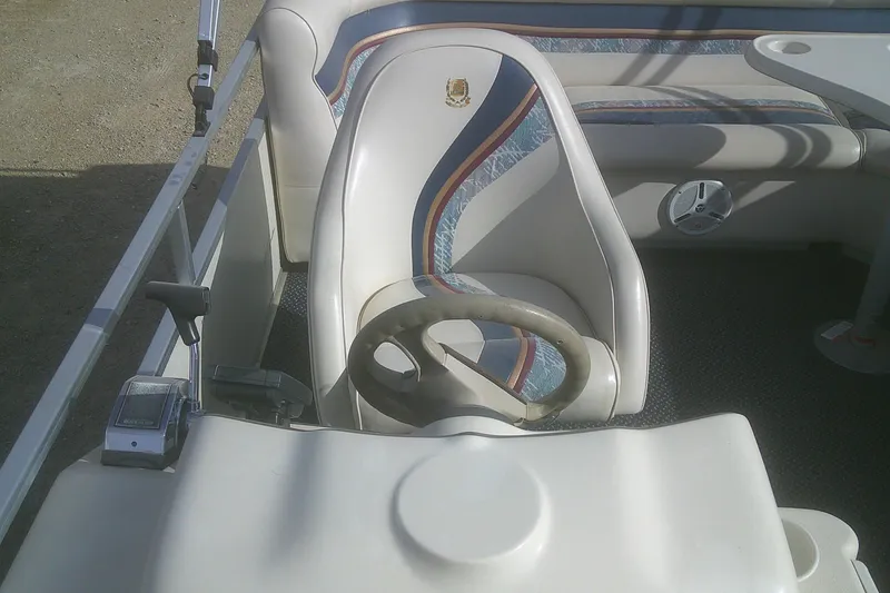 Slide: The Image of 1998 Premier 210 Sunsation boat interior with steering wheel and seating area. - 11