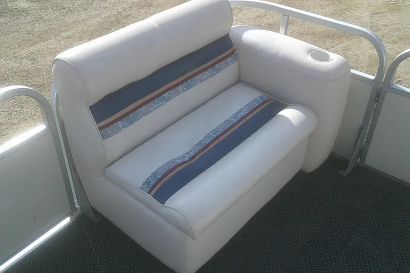 Slide: The Image of Premier 210 Sunsation 1998 boat seat with cup holder, featuring striped upholstery design. - 12