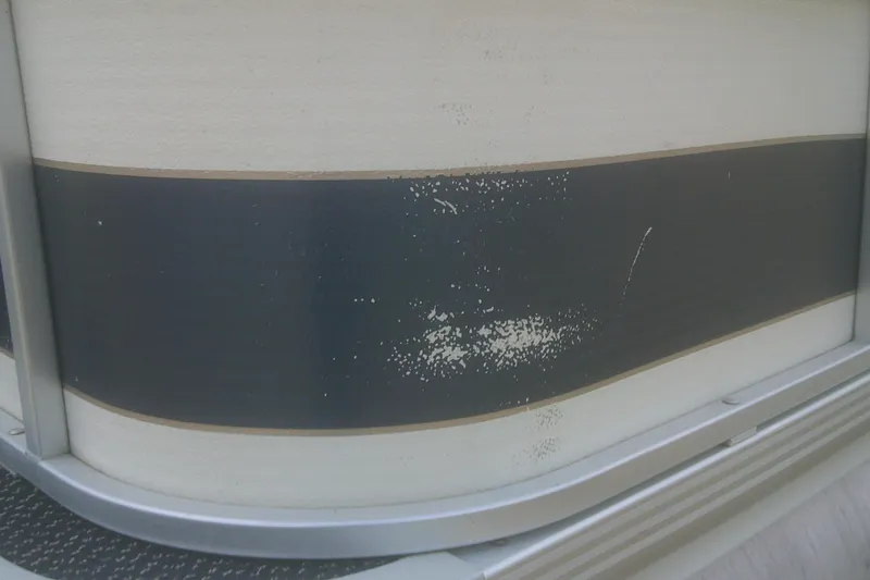 Slide: The Image of 1998 Premier 210 Sunsation boat with peeling paint on the side panel. - 18