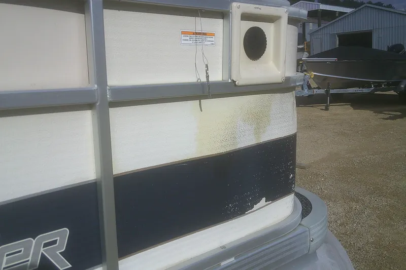 Slide: The Image of 1998 Premier 210 Sunsation boat with visible wear and discoloration on the exterior. - 19