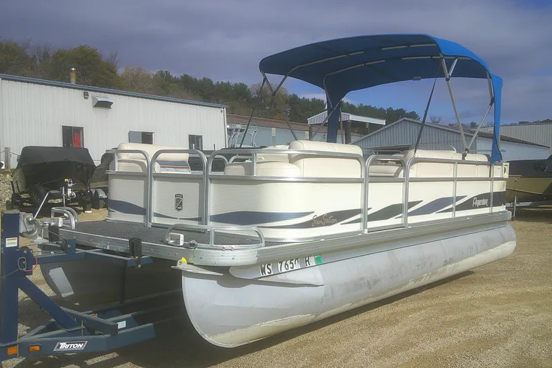 Slide: The Image of 1998 Premier 210 Sunsation pontoon boat with blue canopy on a trailer. - 4