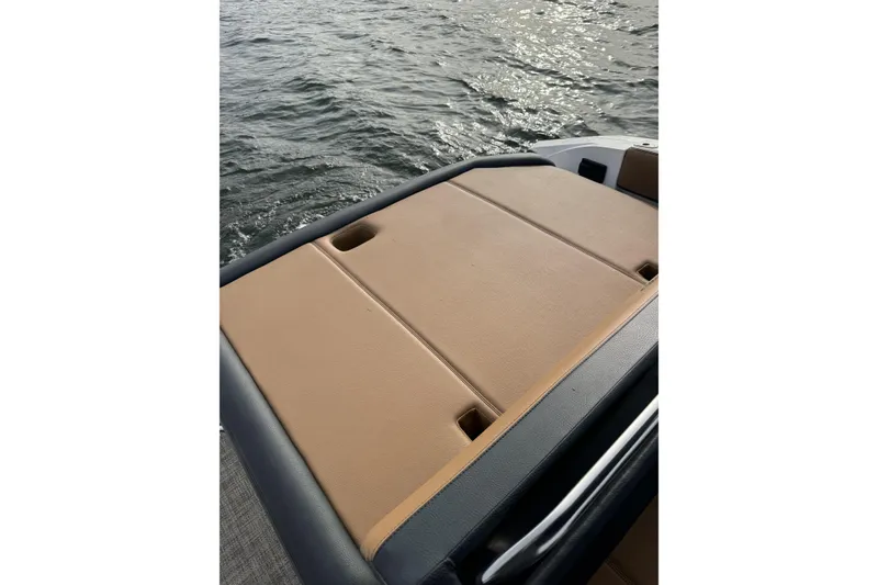Slide: The Image of 2022 Cobalt R4 Surf boat with tan seating, on water. - 10