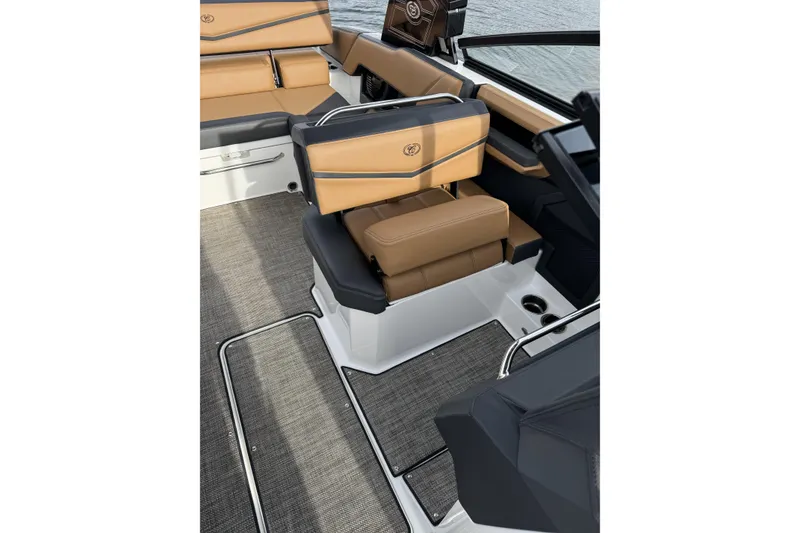 Slide: The Image of 2022 Cobalt R4 Surf boat interior with tan and black seating, gray flooring. - 17