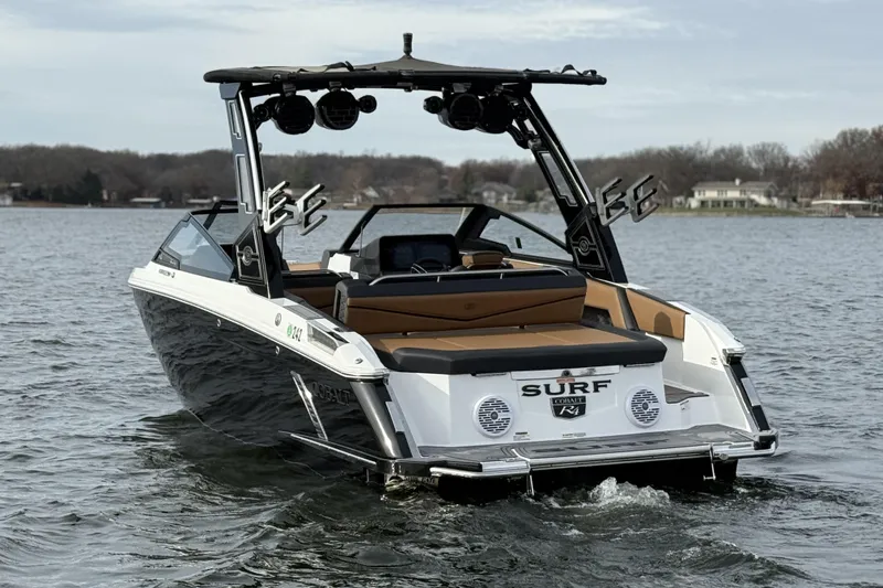 Slide: The Image of 2022 Cobalt R4 Surf boat on a lake, featuring sleek design and modern amenities. - 3