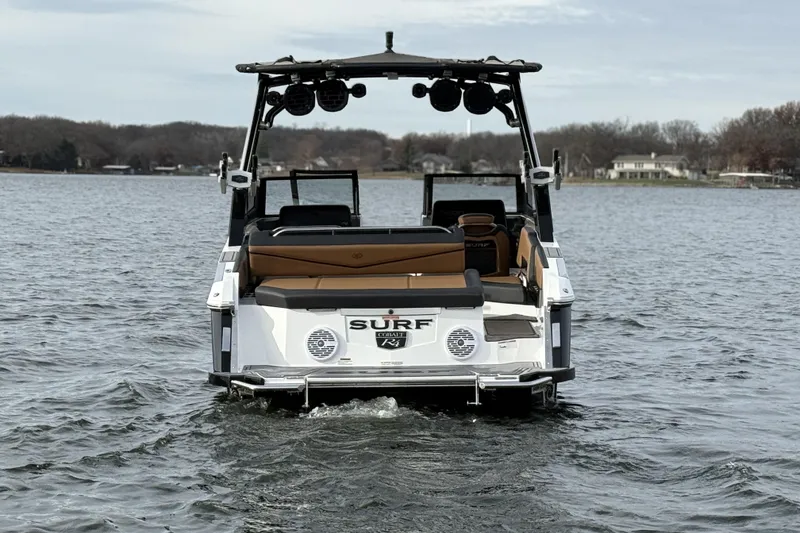 Slide: The Image of 2022 Cobalt R4 Surf boat on a lake, rear view with wakeboard tower. - 4