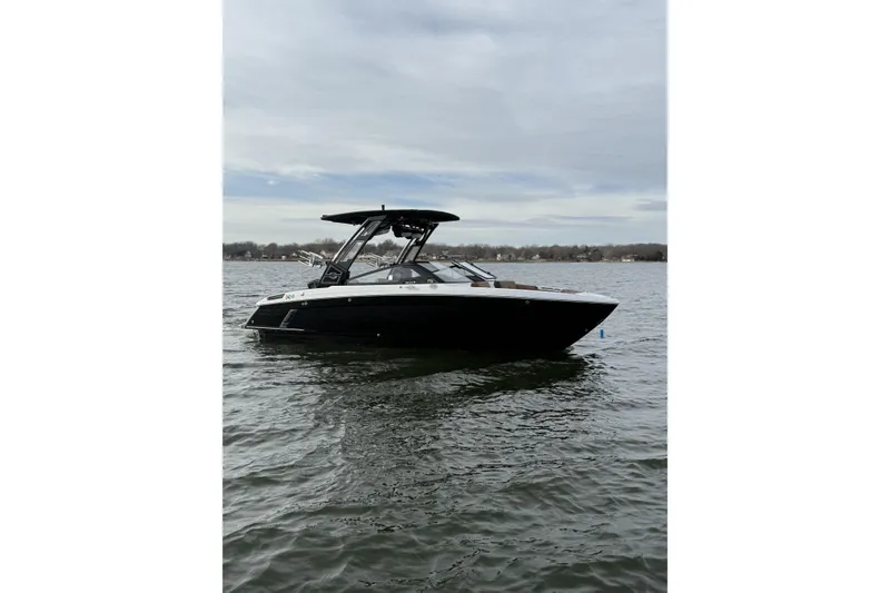 Slide: The Image of 2022 Cobalt R4 Surf boat on calm lake under cloudy sky. - 7