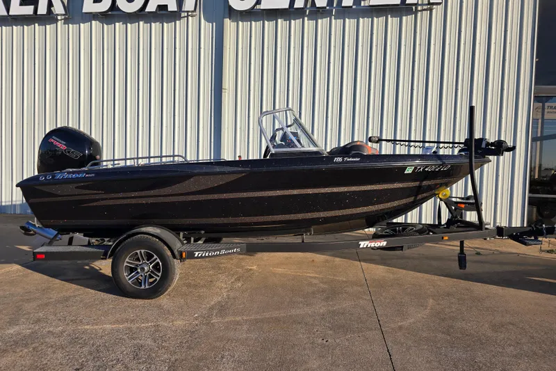 The Image of 2022 Triton 186 Fishunter boat on trailer, parked outside dealership. - 1