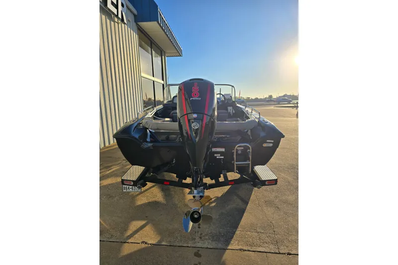 Slide: The Image of 2022 Triton 186 Fishunter boat with powerful outboard motor in sunny setting. - 7