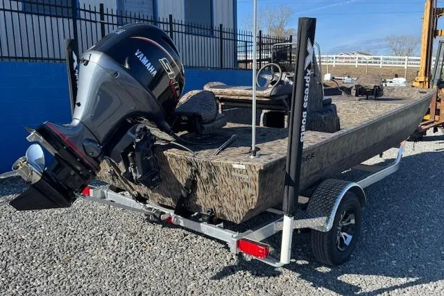 Slide: The Image of 2026 Xpress XP20CC boat with Yamaha engine on trailer, parked on gravel. - 3