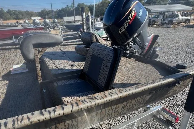 Slide: The Image of 2026 Xpress XP20CC boat with Yamaha engine, camo design, and seating in a marina setting. - 5