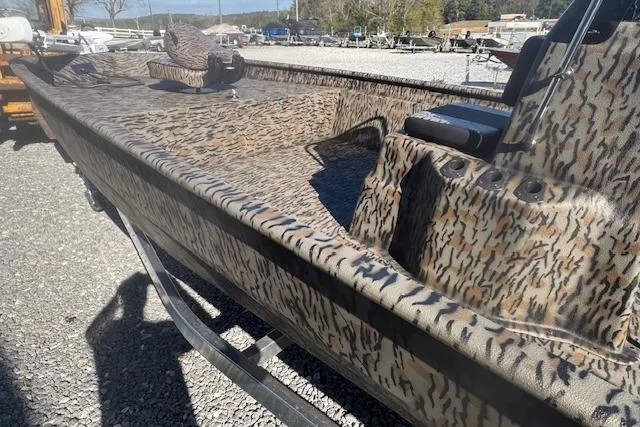 Slide: The Image of 2026 Xpress XP20CC boat with camouflage design on a gravel lot. - 6
