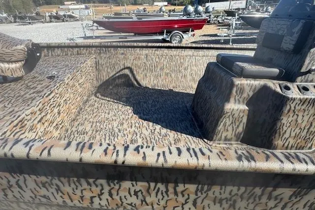 Slide: The Image of 2026 Xpress XP20CC boat with camouflage pattern in a boatyard setting. - 7