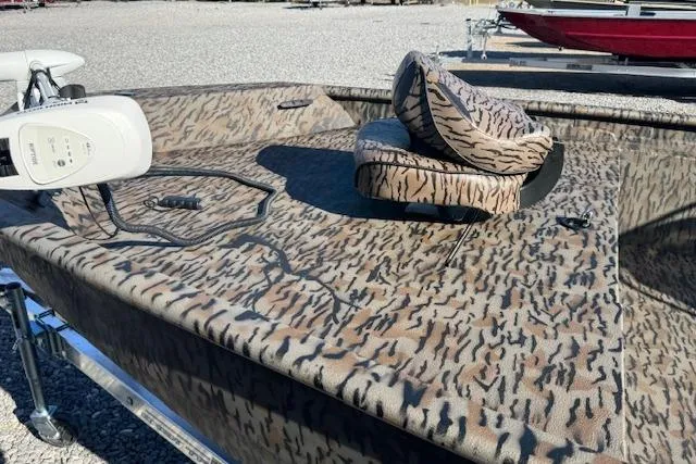 Slide: The Image of 2026 Xpress XP20CC boat with camouflage pattern and seating, featuring a trolling motor. - 9