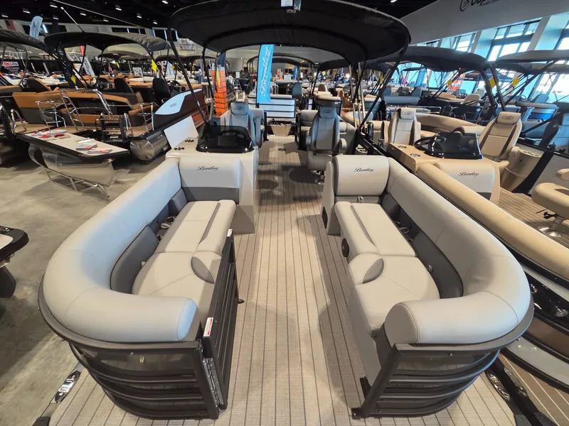 Slide: The Image of 2026 Bentley Pontoons Legacy 220 Navigator at a boat show. - 4