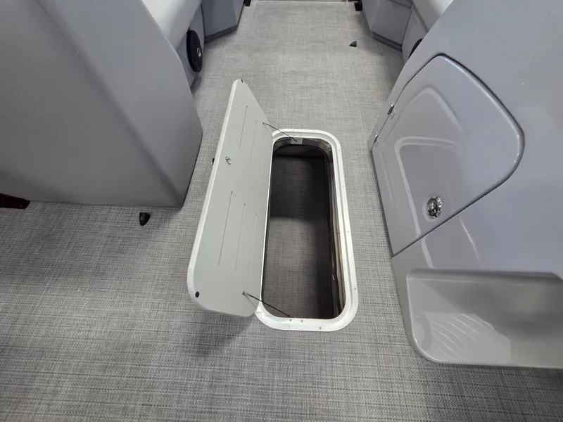 Slide: The Image of Interior of 2026 Bentley Pontoons Legacy 223 Navigator with open storage compartment. - 14