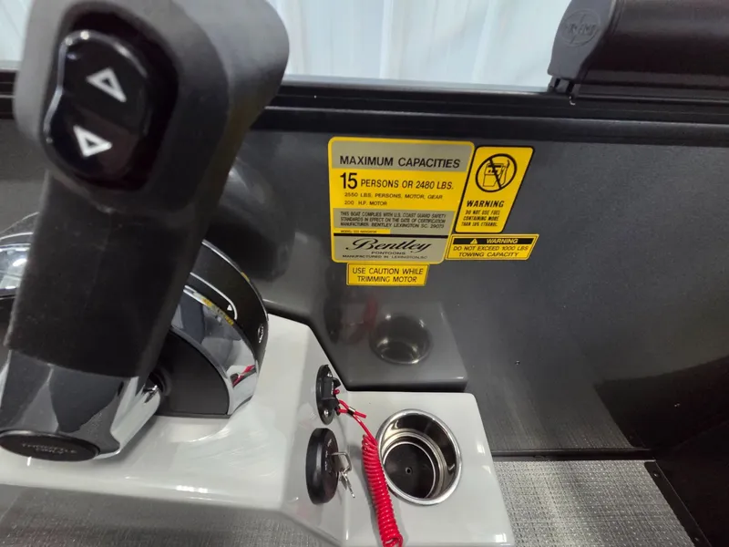 Slide: The Image of Bentley Pontoons Legacy 223 Navigator 2026 console with capacity warning label. - 27