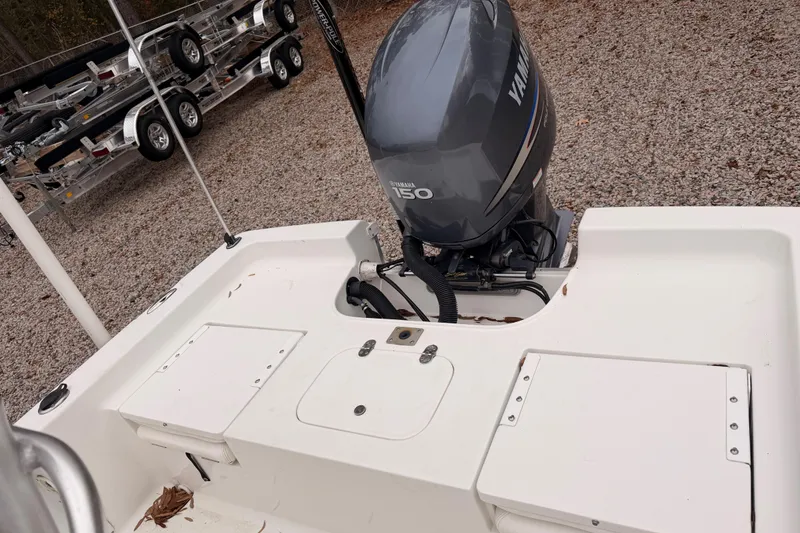 Slide: The Image of 2012 Sea Hunt BX 22 Pro boat with Yamaha 150 engine, parked on gravel. - 3