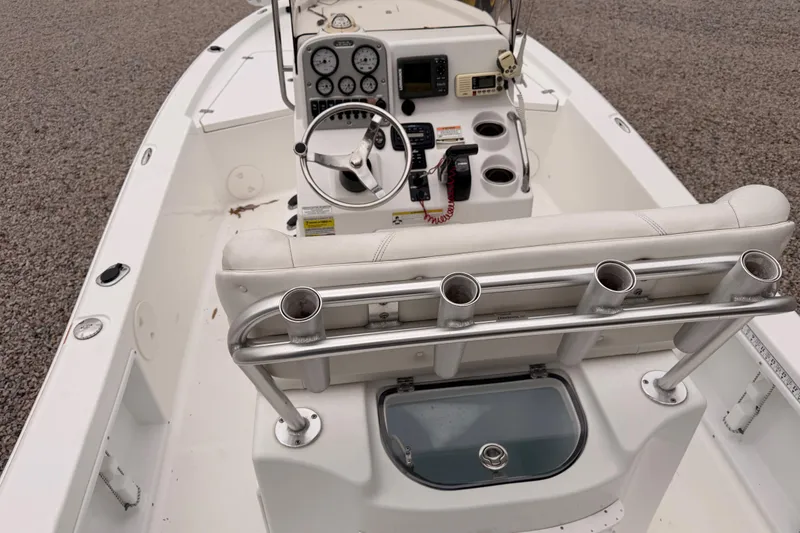 Slide: The Image of 2012 Sea Hunt BX 22 Pro boat interior with steering console and rod holders. - 4