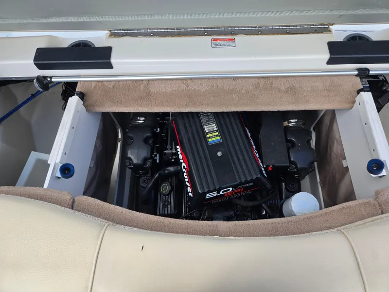 Slide: The Image of Engine compartment of a 1999 Sea Ray 210 BR boat, featuring a MerCruiser 5.0L engine. - 26