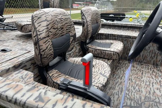 Slide: The Image of 2026 Xpress XP170 boat interior with camouflage seats and steering wheel. - 11
