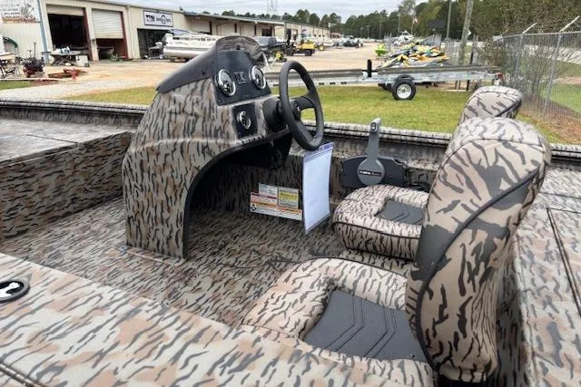 Slide: The Image of 2026 Xpress XP170 boat interior with camouflage design, featuring dual seats and a steering console. - 15