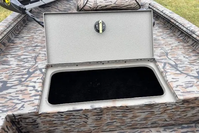 Slide: The Image of 2026 Xpress XP170 boat with open storage compartment, camo pattern design. - 17