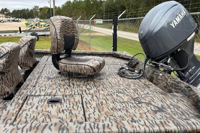 Slide: The Image of 2026 Xpress XP170 boat with camouflage seats and Yamaha outboard motor. - 7
