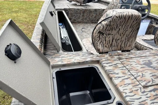 Slide: The Image of 2026 Xpress XP170 boat interior with camo seats and open storage compartments. - 9