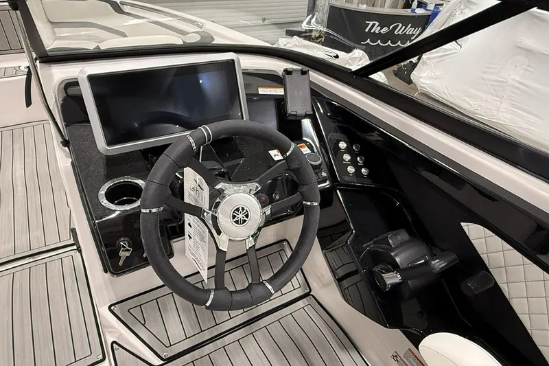 Slide: The Image of 2025 Yamaha Boats 252S dashboard with steering wheel, touchscreen, and controls. - 4