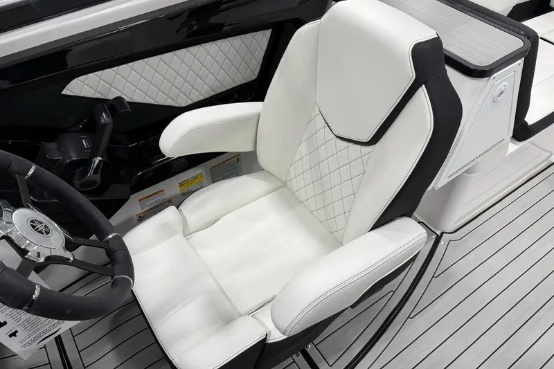 Slide: The Image of 2025 Yamaha Boats 252S cockpit with luxurious white seating and sleek steering wheel design. - 7