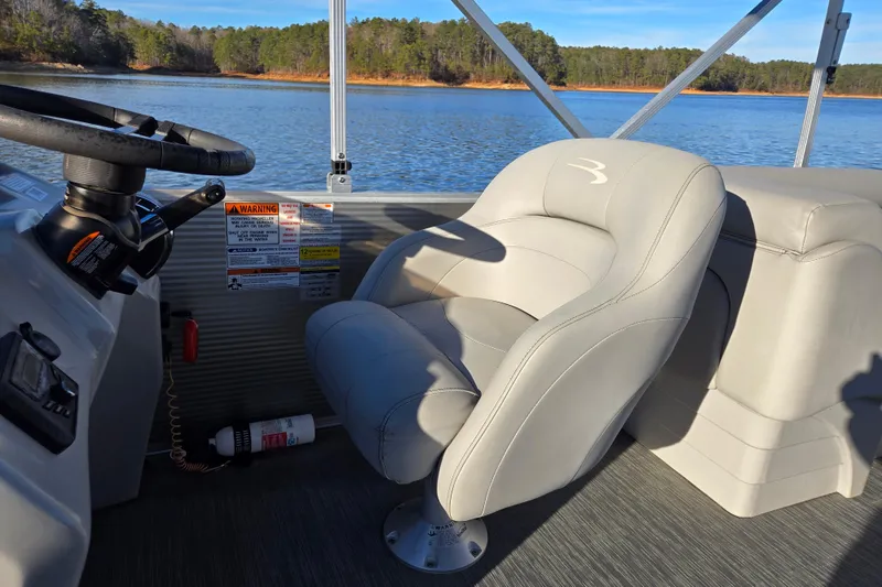 Slide: The Image of 2023 Bennington 22 SSR boat interior with steering wheel and comfortable seating. - 17