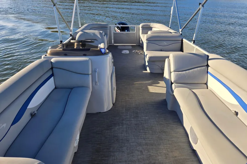 Slide: The Image of 2023 Bennington 22 SSR pontoon boat interior with spacious seating on water. - 9