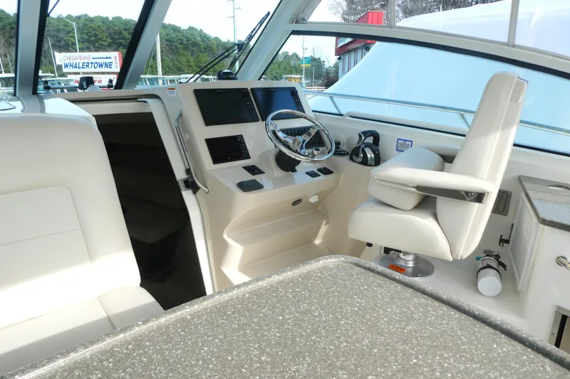 Slide: The Image of 2020 Boston Whaler 345 Conquest helm with modern controls and comfortable seating. - 10