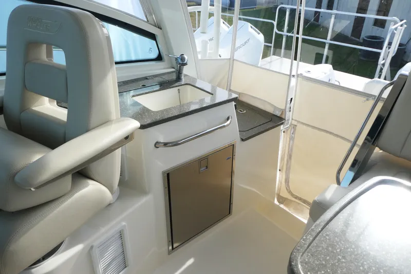 Slide: The Image of Interior of 2020 Boston Whaler 345 Conquest boat with sink and seating area. - 11