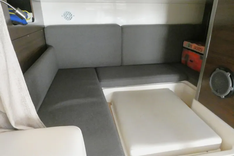 Slide: The Image of 2020 Boston Whaler 345 Conquest cabin interior with gray seating and life jackets. - 17