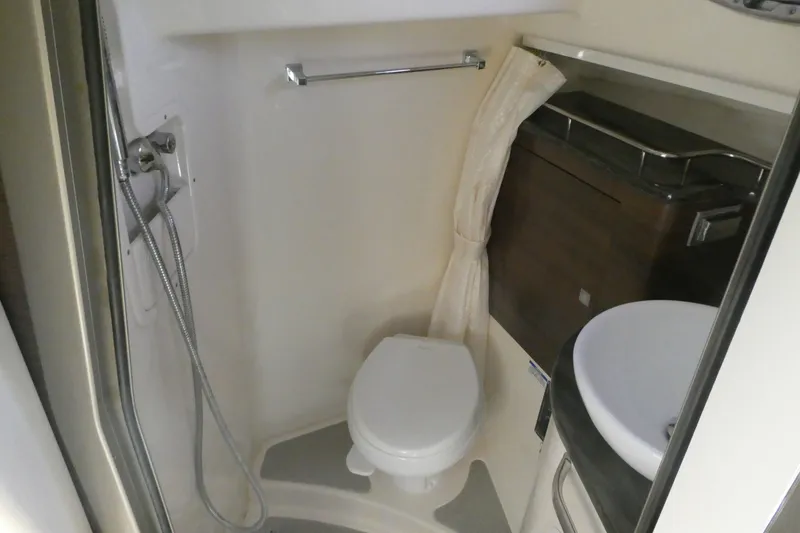Slide: The Image of Bathroom interior of 2020 Boston Whaler 345 Conquest boat, featuring toilet and shower. - 19