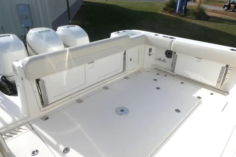 Slide: The Image of 2020 Boston Whaler 345 Conquest boat deck with triple outboard engines. - 3