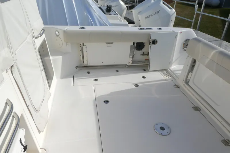 Slide: The Image of 2020 Boston Whaler 345 Conquest boat deck with storage compartments and Mercury engines. - 5
