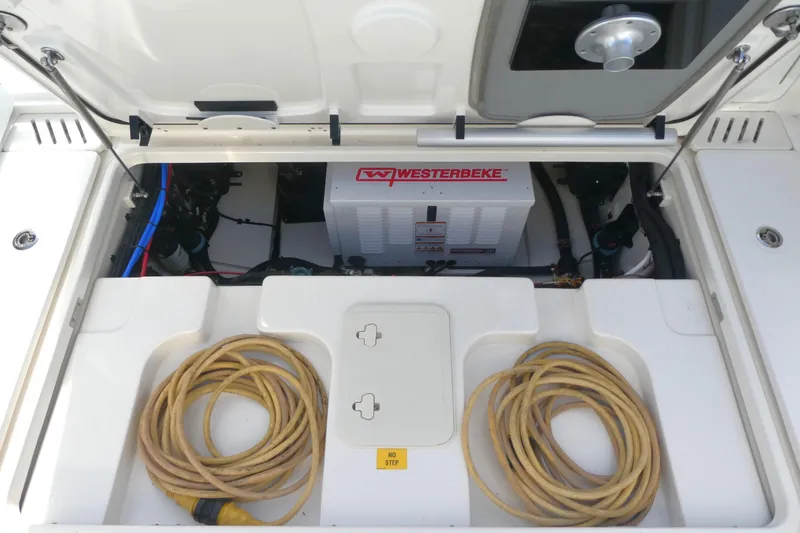 Slide: The Image of Engine compartment of 2020 Boston Whaler 345 Conquest with Westerbeke generator and coiled cables. - 6