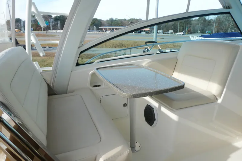 Slide: The Image of 2020 Boston Whaler 345 Conquest interior with seating and table, showcasing luxury design. - 9