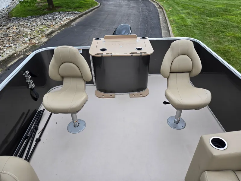 Slide: The Image of 2022 Sylvan Mirage Fish 822 Party Fish boat interior with beige seats and fishing setup. - 17